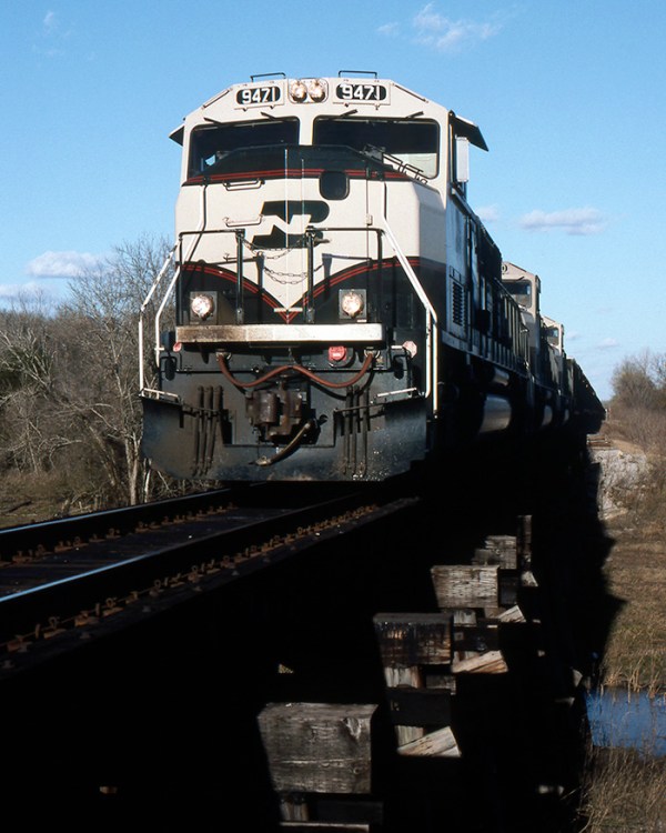 3 SD70MAC's deliver another load of Powder River Basin coal to the HL&P Parrish Plant just outside of Rosenberg, TX on Dec. 27, 1997