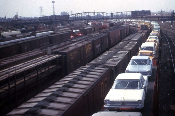 New Plymouth autos on railcars in St Louis in 1966