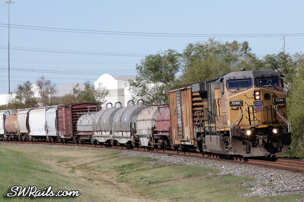 UP AC4400CW 7046 leading freight train MEGEW at Stafford TX